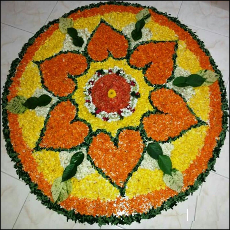 Rangoli design using flower petals and leaves